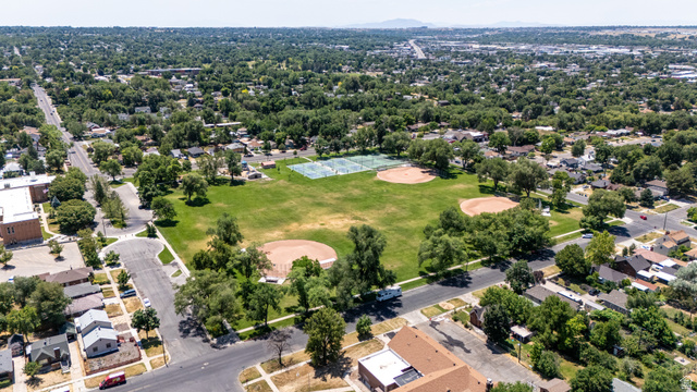 2862 Fowler Avenue Ogden, UT 84403 - Photo 22 of 23 Aerial perspective showcasing a large community park with multiple baseball diamonds and tennis courts, surrounded by tree-lined streets and residential properties