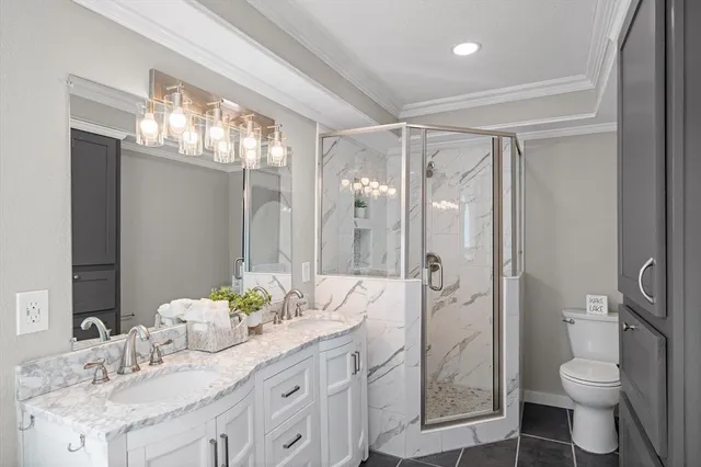 a bathroom with a granite countertop sink toilet a large mirror a shower and
