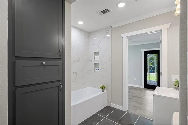 a bathroom with a bathtub and a shower