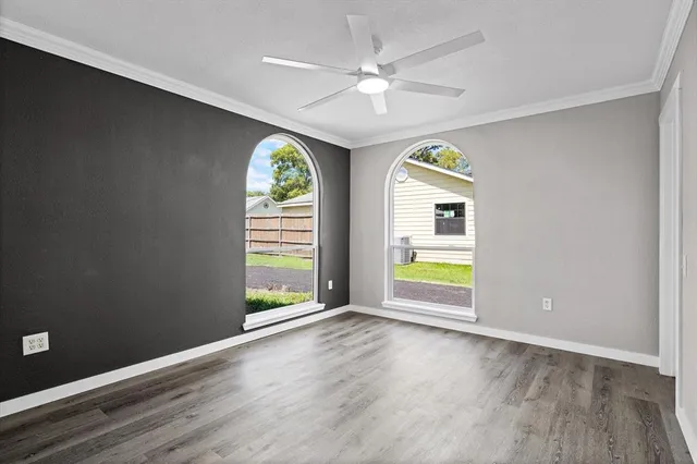 wooden floor in an empty room with a window