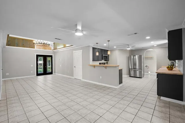 a open kitchen with cabinets and stainless steel appliances