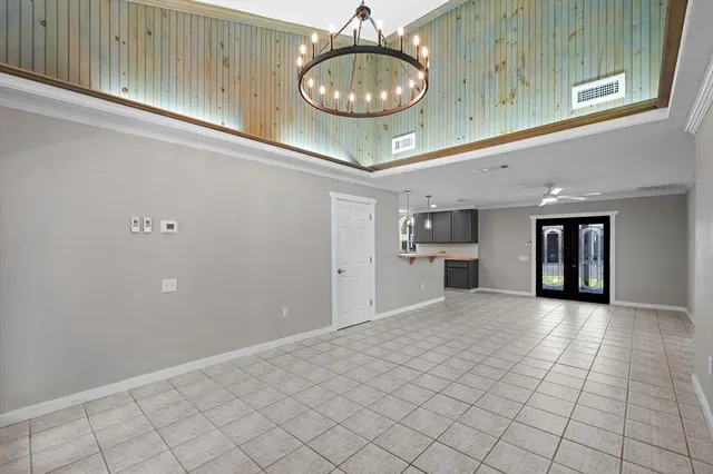 a view of an empty room and kitchen