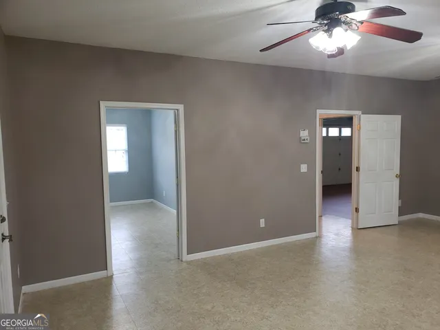 a bathroom with a granite countertop sink toilet a large mirror a bathtub and shower
