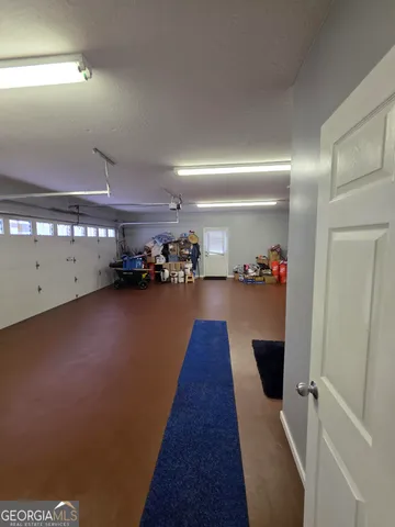 an empty room with wooden floor and staircase