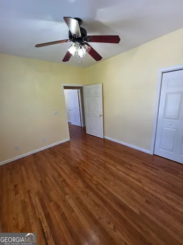 a view of a livingroom with a ceiling fan a flat screen tv and a ceiling fan