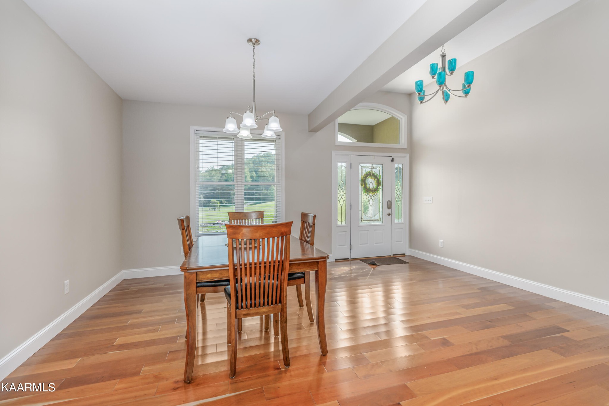 1335 Deep Springs Road Dandridge, TN 37725 - Photo 20 of 30 a dining room with wooden floor a chandelier a wooden table and chairs