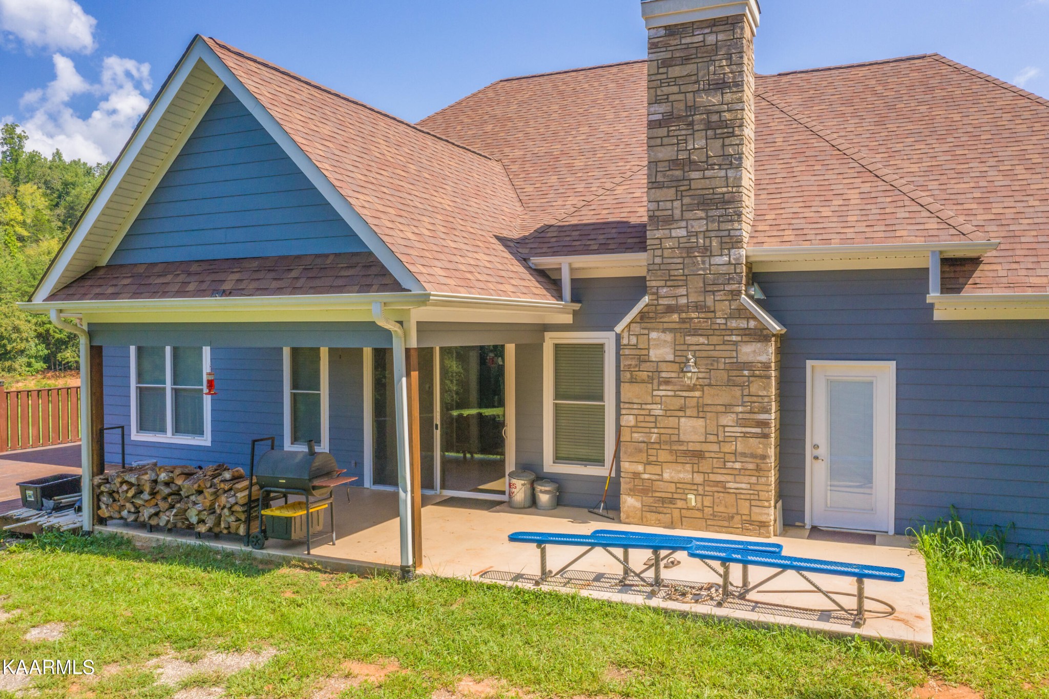 1335 Deep Springs Road Dandridge, TN 37725 - Photo 4 of 30 a front view of a house with a yard table and chairs