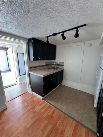 a kitchen with stainless steel appliances granite countertop a sink and a stove top oven