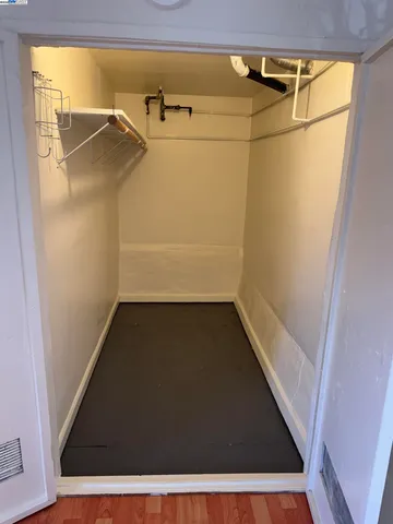 a view of walk in closet with empty racks