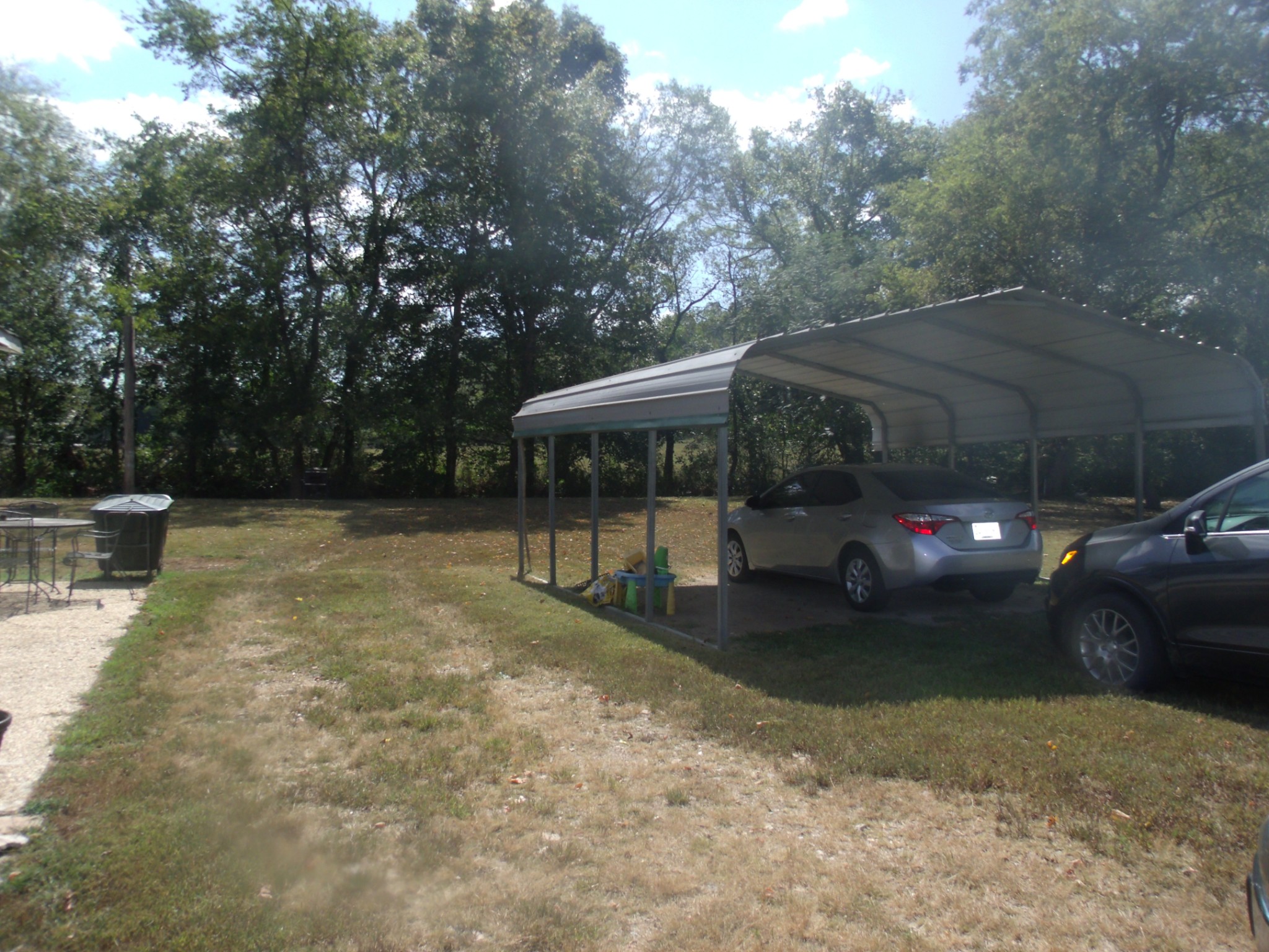 1310 Bevels Spring Road Goodspring, TN 38460 - Photo 25 of 30 a view of a patio with table and chairs under an umbrella with large trees