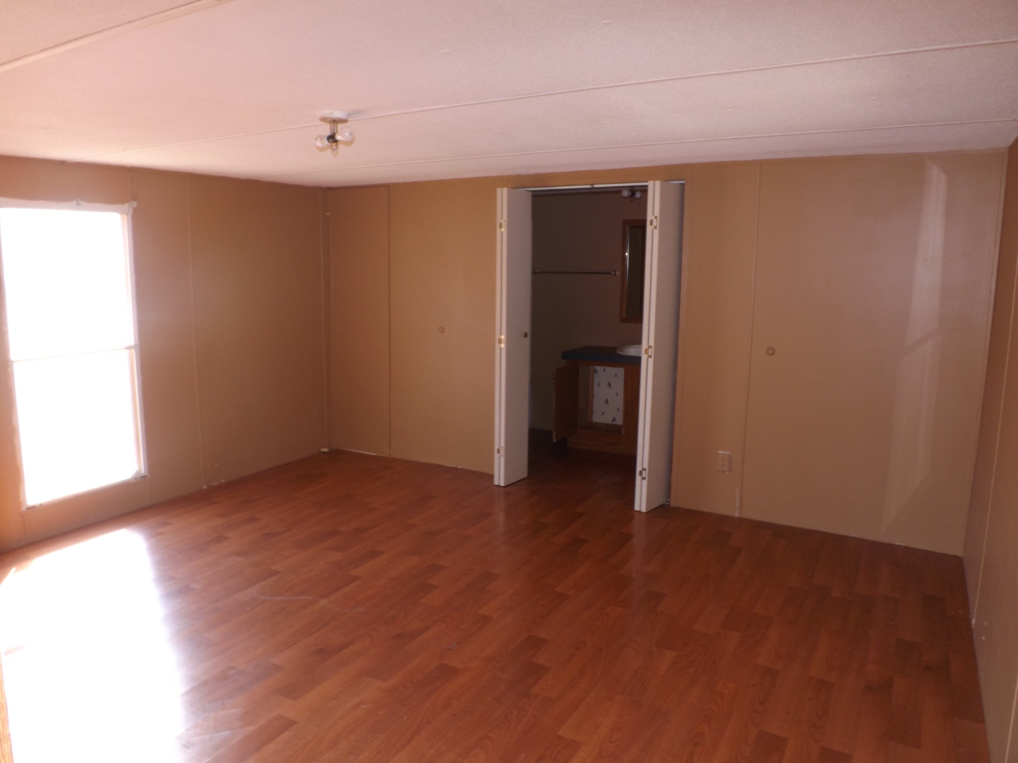 1310 Bevels Spring Road Goodspring, TN 38460 - Photo 10 of 30 a view of an empty room with wooden floor and a window