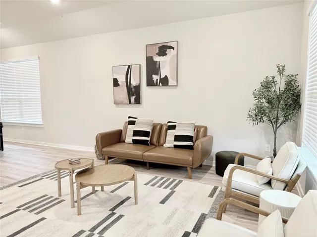 a living room with furniture and a potted plant