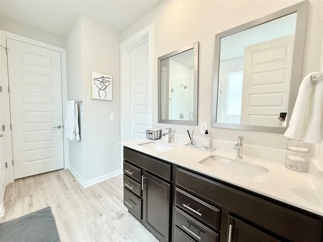 a bathroom with a sink double vanity and a mirror