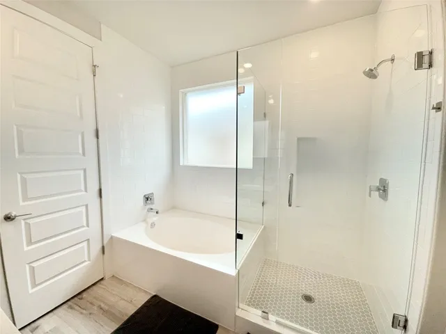 a bathroom with a bathtub and a shower
