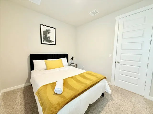 a bed sitting in a bedroom next to a window