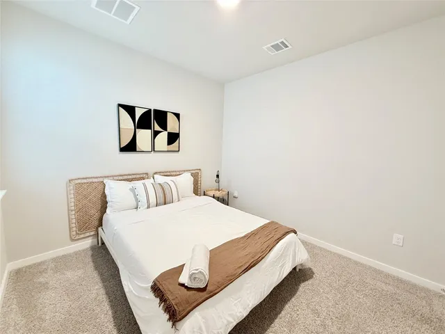 a bedroom with a bed and wall painting