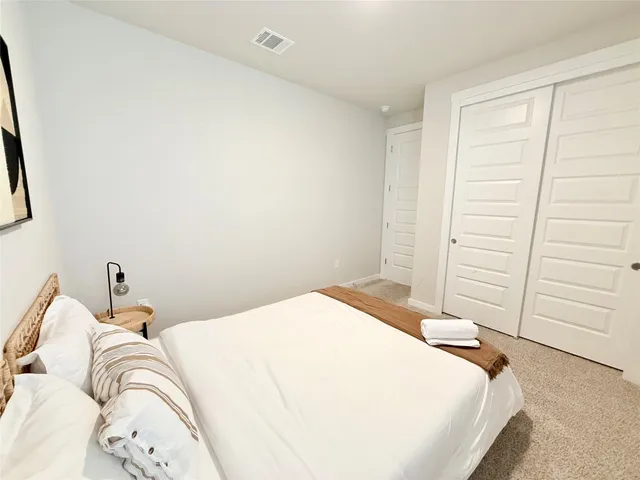 a bedroom with a bed and a cabinets