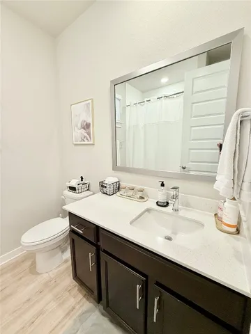 a bathroom with a double vanity sink toilet and a mirror