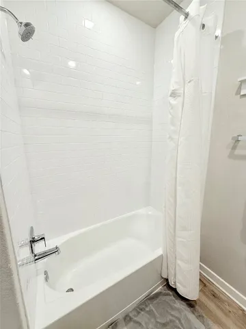 a bathroom with a bathtub and a shower