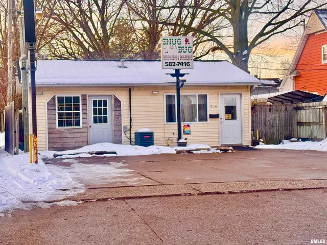 a front view of a house with yard and garage