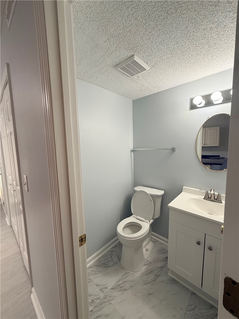 613 Brock Street Central, SC 29630 - Photo 11 of 28 This bright bathroom features a modern vanity and toilet, complemented by stylish flooring.