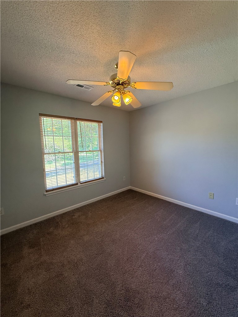 613 Brock Street Central, SC 29630 - Photo 17 of 28 This spacious bedroom offers ample natural light and a comfortable atmosphere for relaxation.