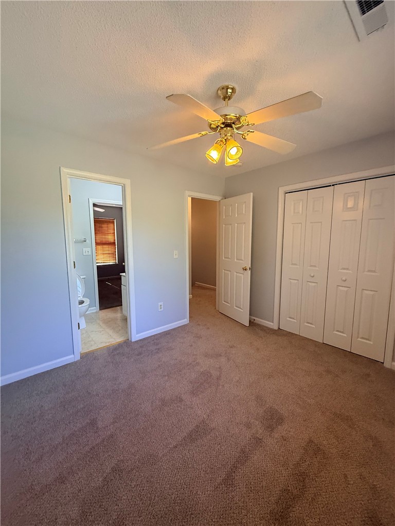 613 Brock Street Central, SC 29630 - Photo 18 of 28 This cozy bedroom features a ceiling fan, closet, and carpeted flooring, providing comfort and convenience.