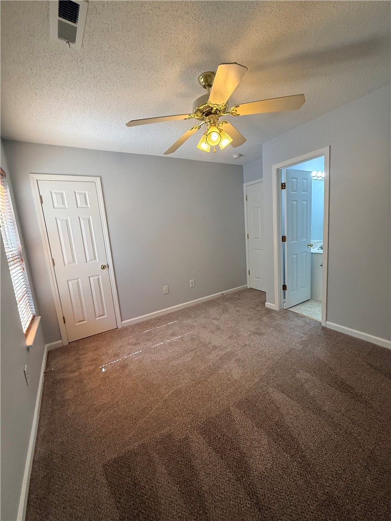 613 Brock Street Central, SC 29630 - Photo 23 of 28 This spacious bedroom offers comfortable carpeting and a ceiling fan, ensuring a pleasant living space.