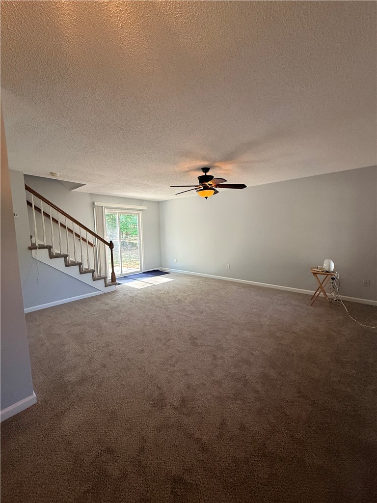 613 Brock Street Central, SC 29630 - Photo 3 of 28 This living area features a carpeted floor and sliding glass doors that open to the outside.