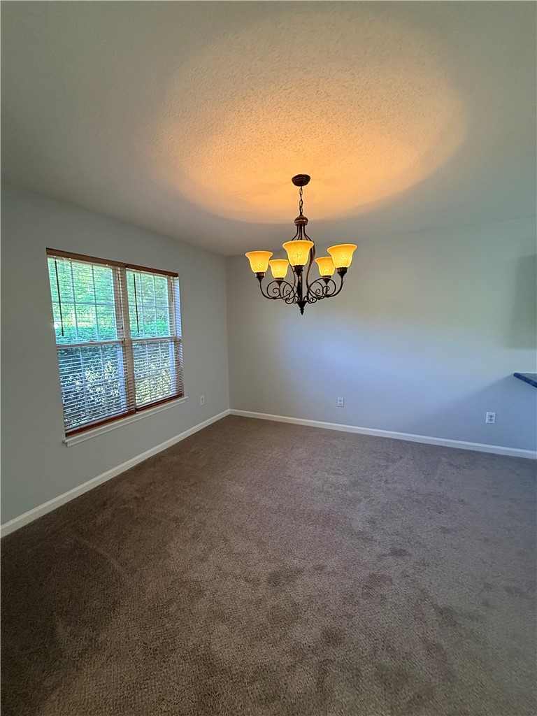 613 Brock Street Central, SC 29630 - Photo 6 of 28 This versatile room features warm lighting and a tranquil view, ideal for gatherings or quiet moments.