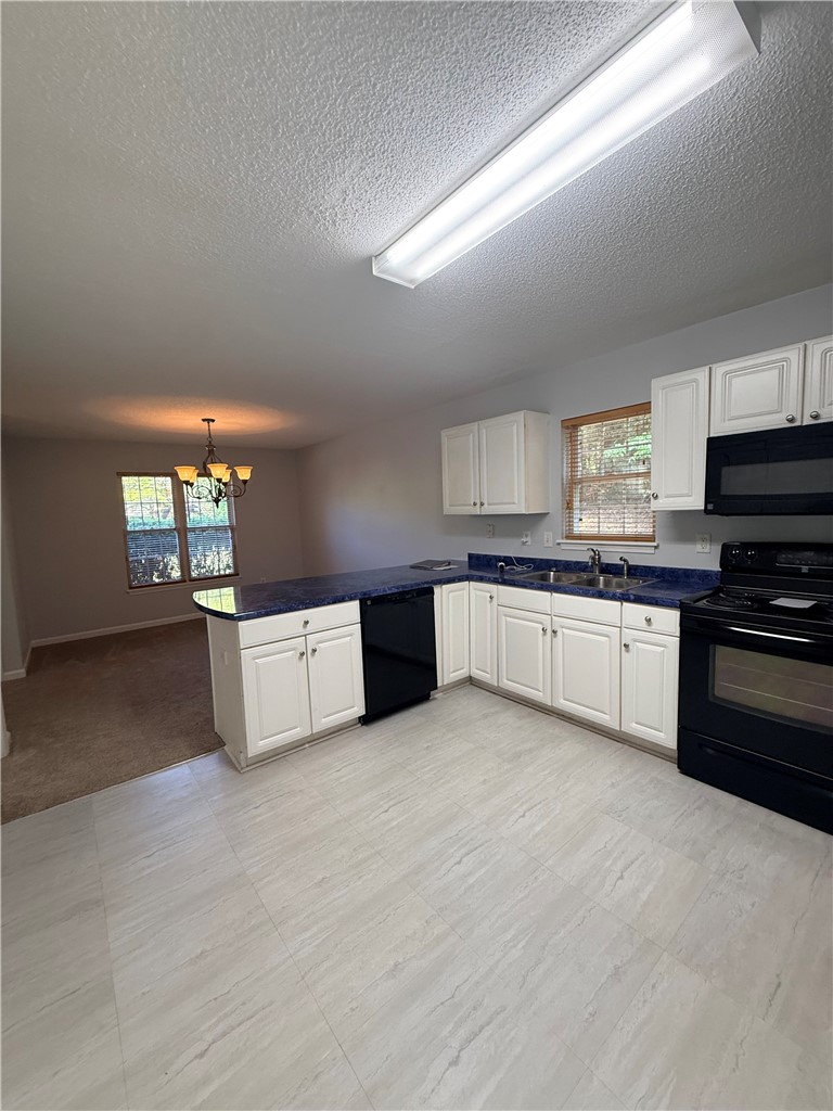 613 Brock Street Central, SC 29630 - Photo 9 of 28 This spacious kitchen offers ample counter space and connects seamlessly to the dining area.