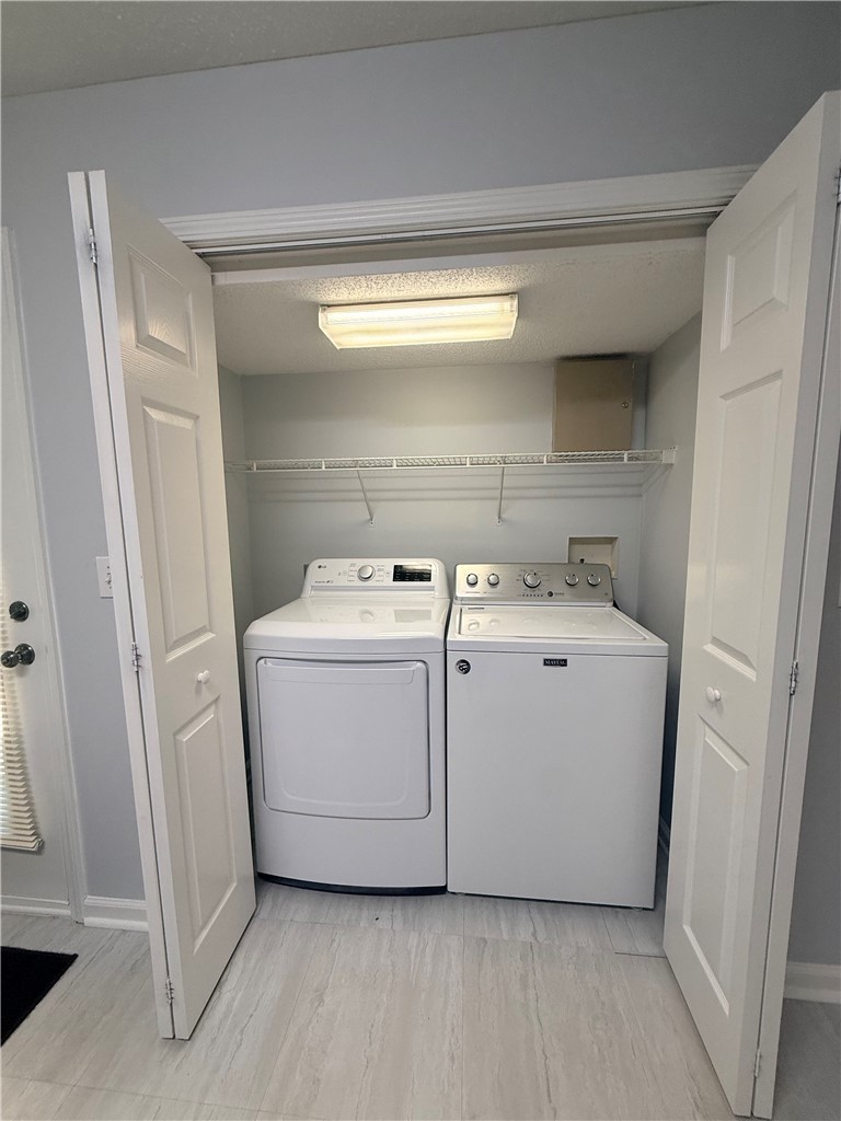 613 Brock Street Central, SC 29630 - Photo 10 of 28 This convenient laundry area features essential appliances and practical shelving for organization.