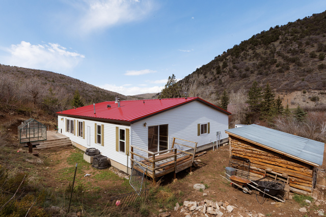 3902 Beaver Creek Road Kamas, UT 84036 - Photo 24 of 33 View of house with a metal roof, accessory building, greenhouse and a deck with mountain view