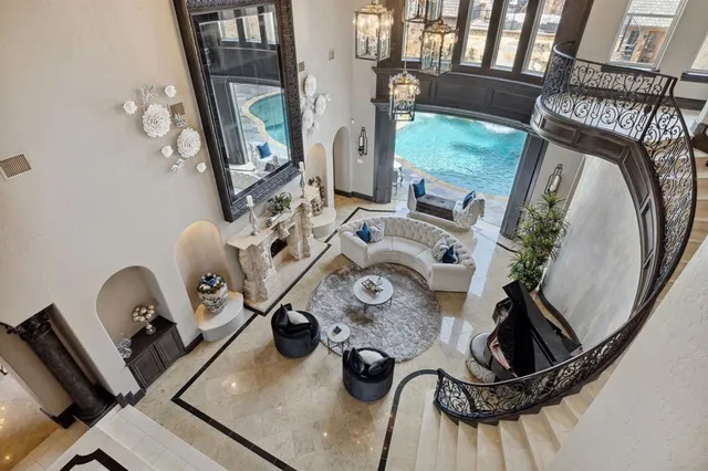 a living room with furniture and a chandelier