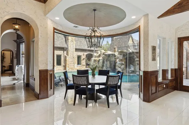 a living room with furniture pool table wooden floor and a rug