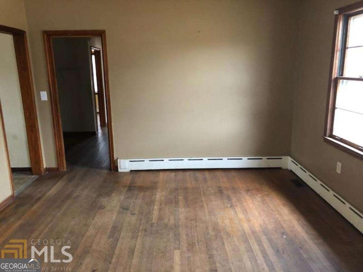329 McDonough Road Jackson, GA 30233 - Photo 11 of 11 an empty room with wooden floor and windows