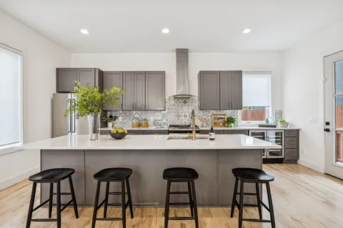 a kitchen with stainless steel appliances a stove and a refrigerator