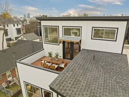 an aerial view of a residential building with an outdoor space