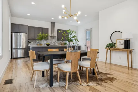 a view of a dining room with furniture and wooden floor