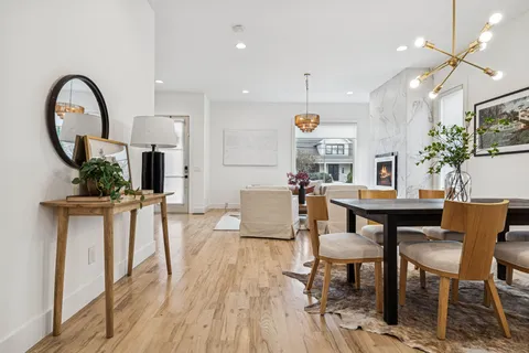a view of a dining room with furniture and a potted plant