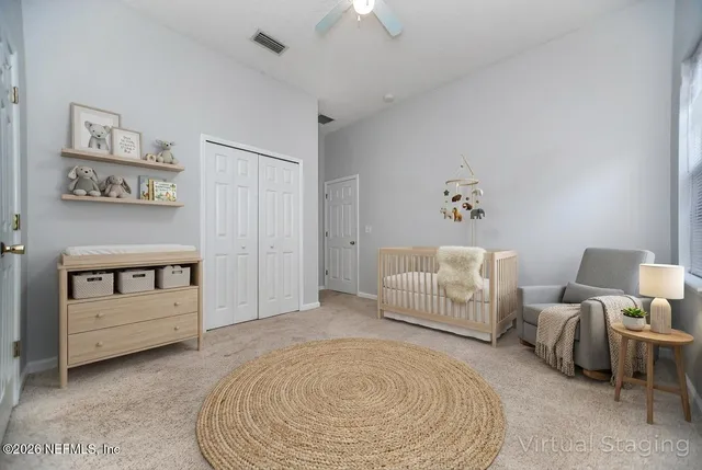 a spacious bedroom with a bed and a couch