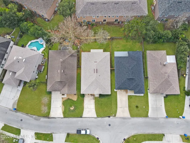 an aerial view of residential houses with outdoor space and street view