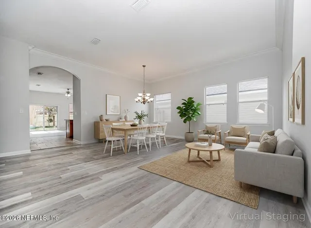 a living room with furniture and a chandelier