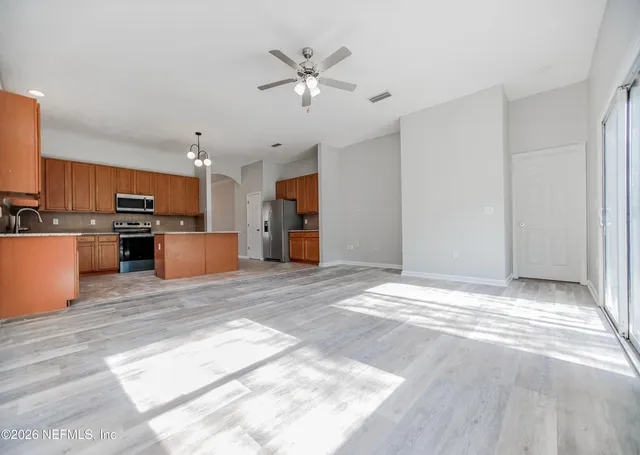 a view of a kitchen with a sink and a refrigerator