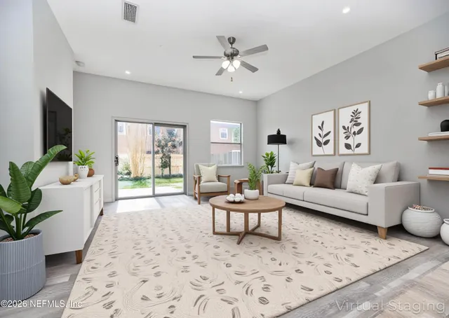 a living room with furniture and a large window