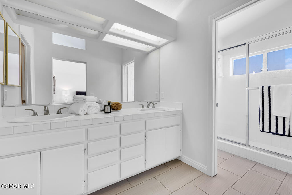 2676 Santa Ynez Avenue Simi Valley, CA 93063 - Photo 16 of 46 a bathroom with a double vanity sink and a mirror