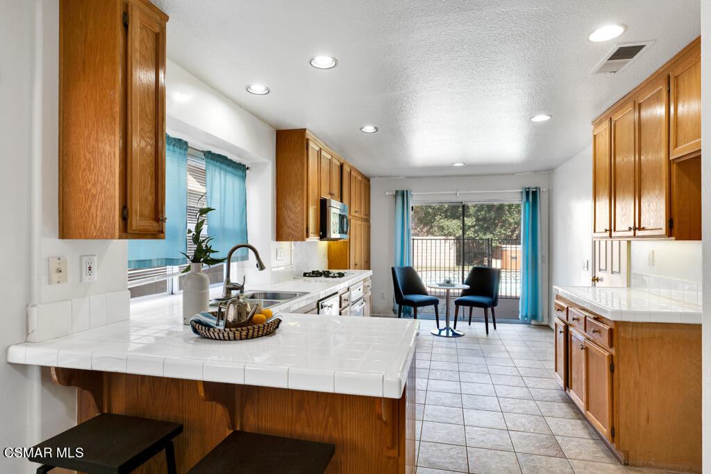 2676 Santa Ynez Avenue Simi Valley, CA 93063 - Photo 4 of 46 a dining hall with dining table and chairs