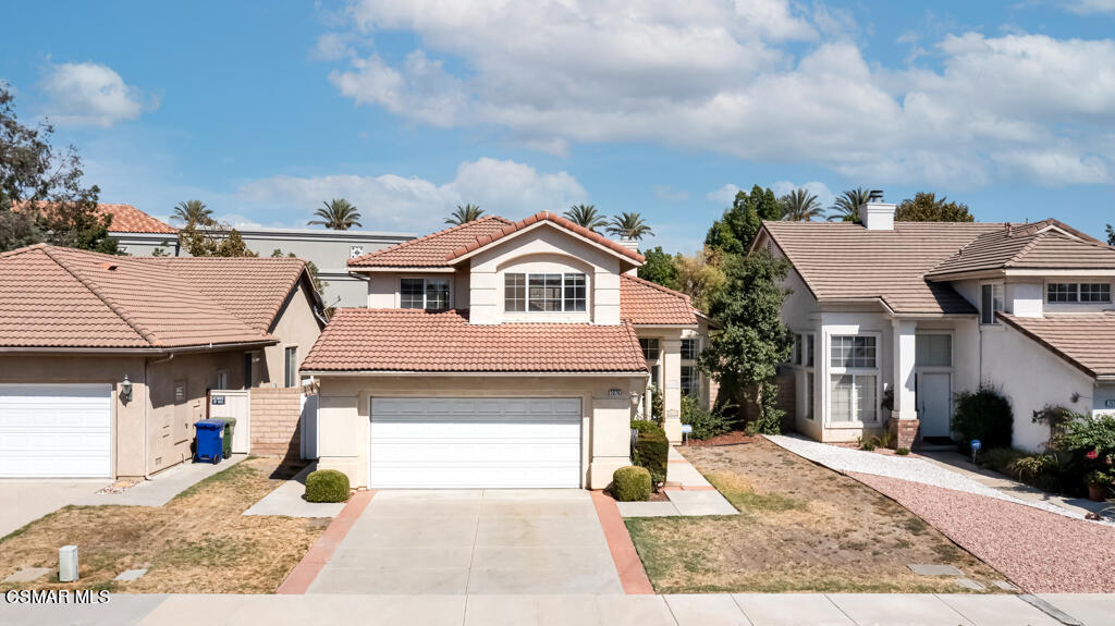 2676 Santa Ynez Avenue Simi Valley, CA 93063 - Photo 45 of 46 a front view of a house with a yard and garage