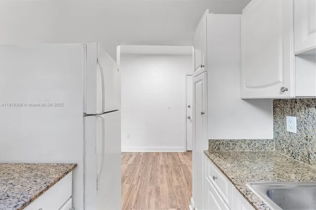 a view of kitchen island with wooden floor