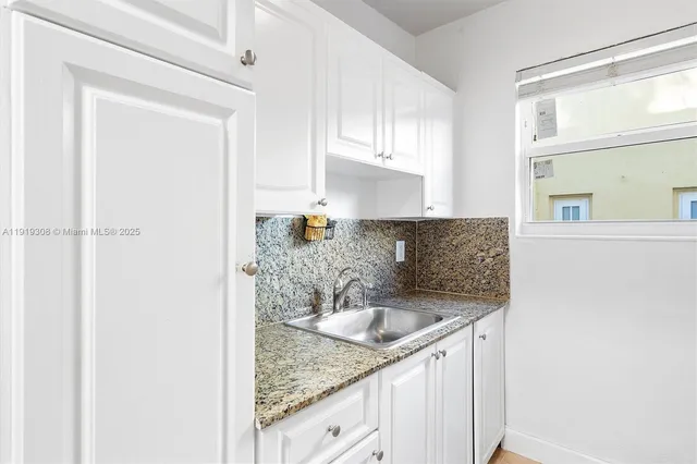 a kitchen with granite countertop a sink and a granite counter tops